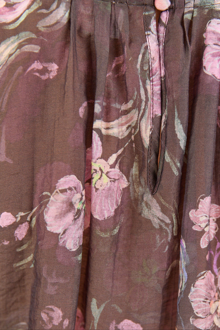 Floral-patterned pants with a focus on the waistband and fabric texture.