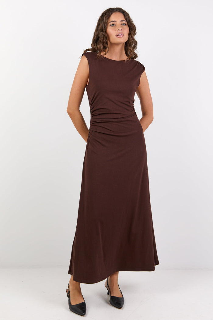 Woman wearing a brown dress on a white background