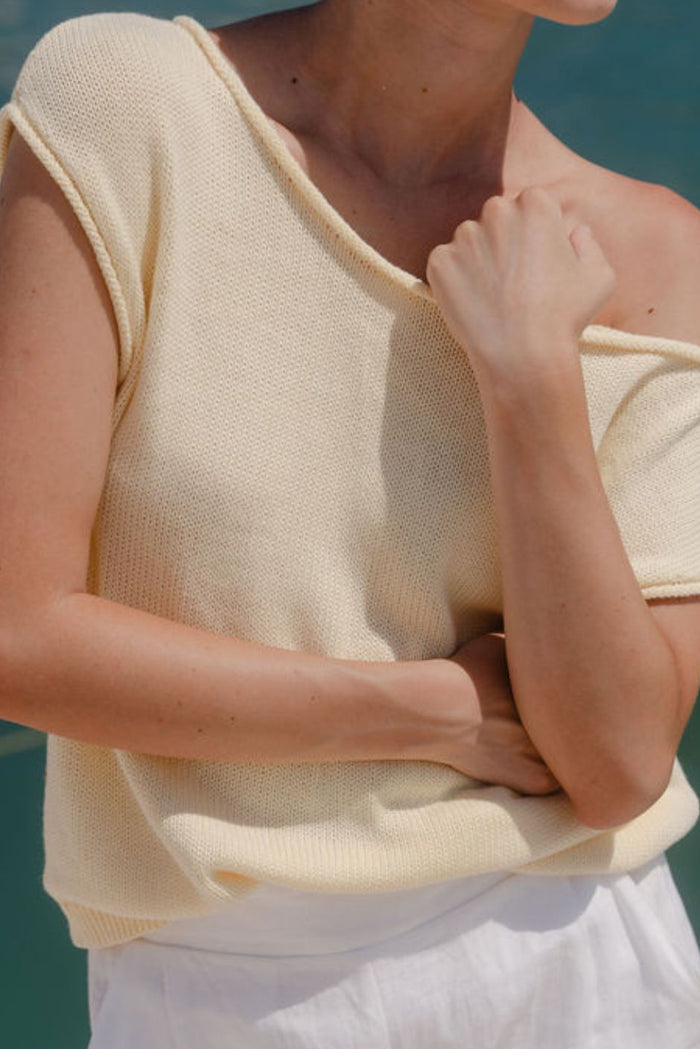 Woman wearing butter yellow knit top