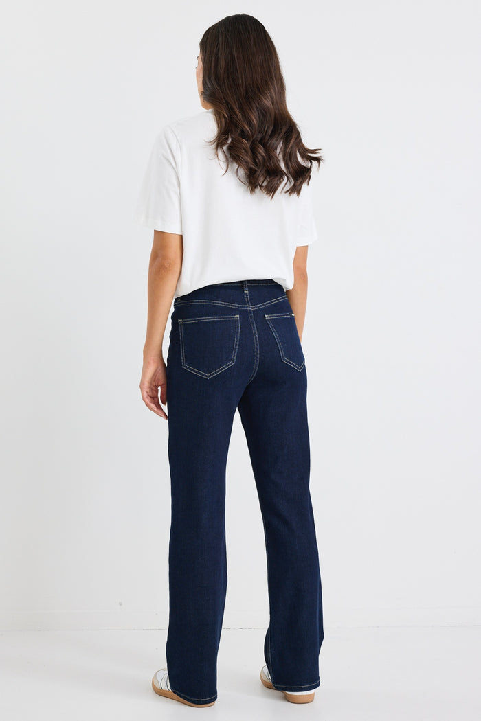model wears a dark blue jean with a white t-shirt