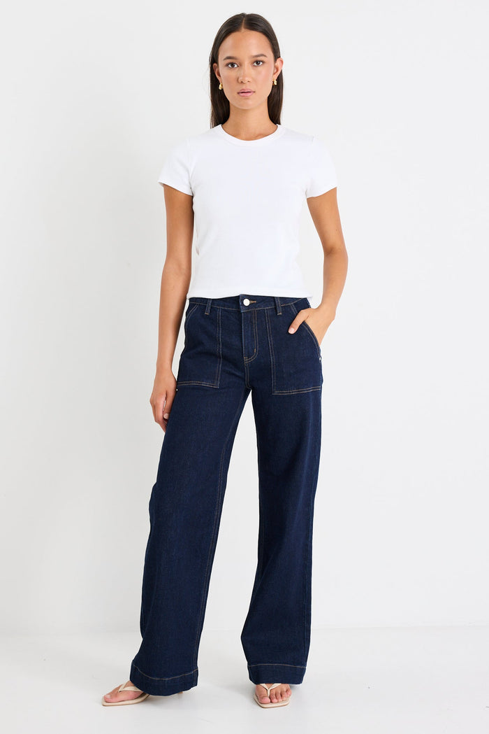 Woman wearing a dark denim jean and white tee