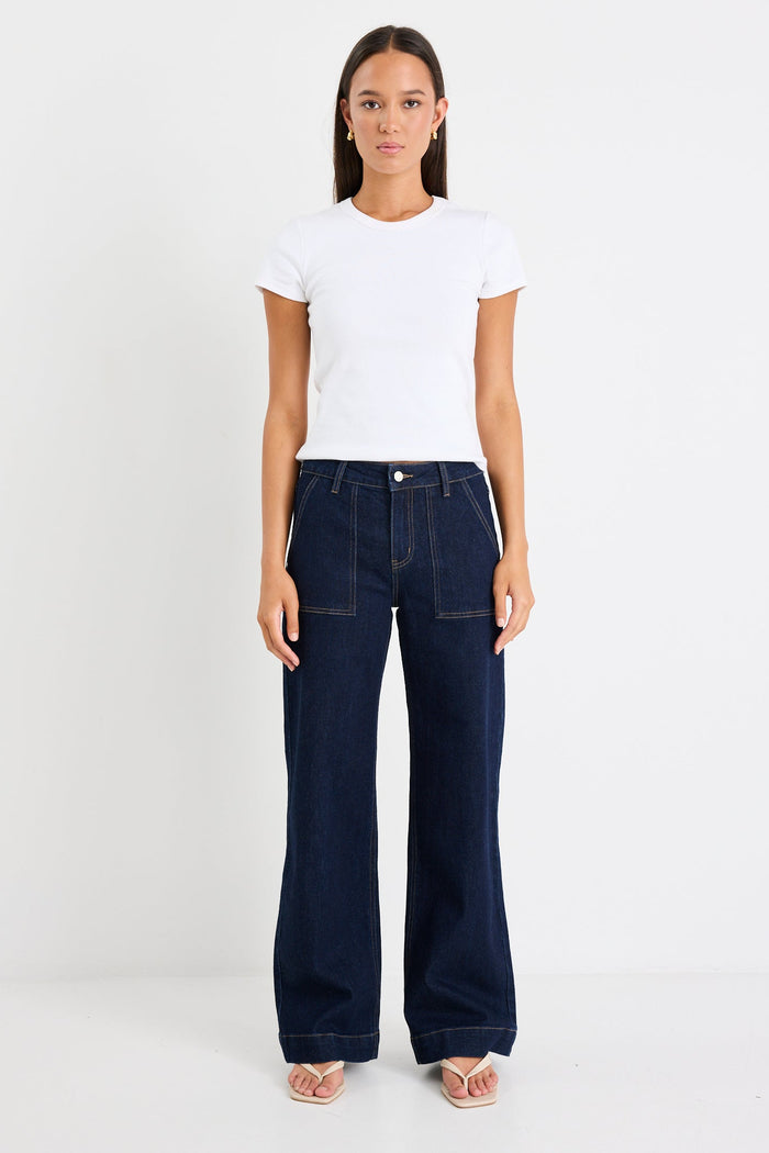 Woman wearing a dark denim jean and white tee