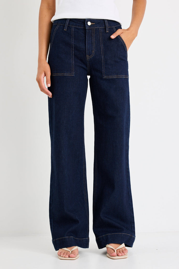 Woman wearing a dark denim jean and white tee