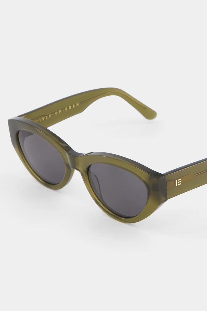 Sunglasses with a green frame and dark lenses on a white background