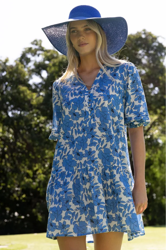 Woman wears a blue white mini smock dress