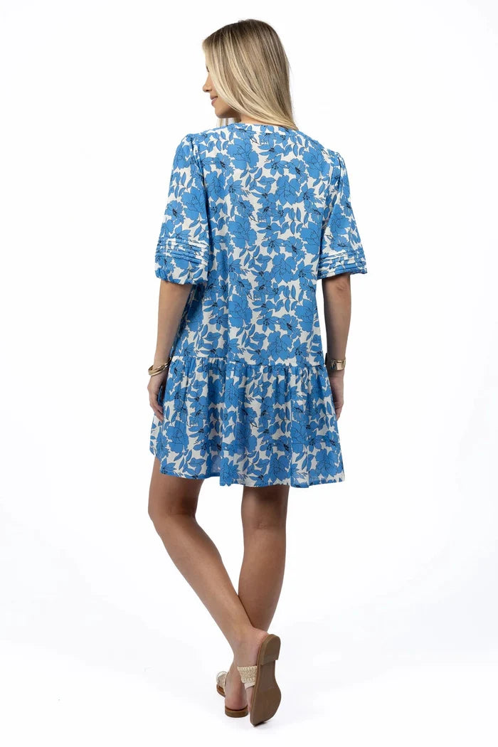 Woman wears a blue white mini smock dress
