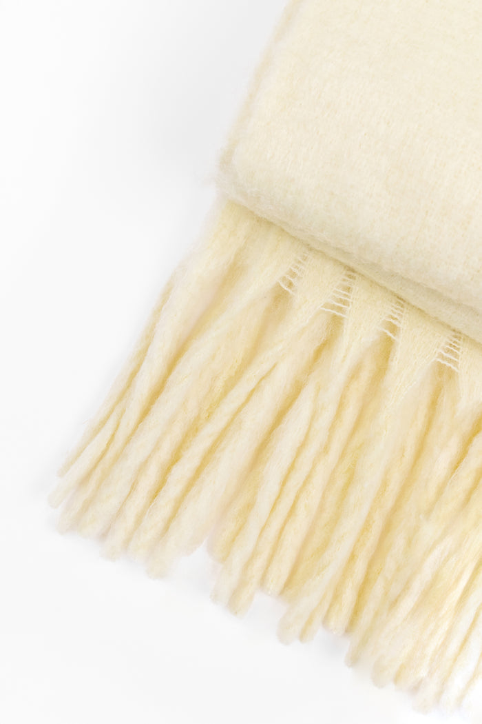 Lemon yellow coloured scarf on a white background