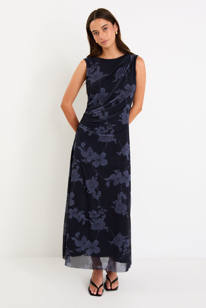 Model wearing a sleeveless midnight floral mesh maxi dress with gentle gathering at the waist and a slim, draped silhouette.