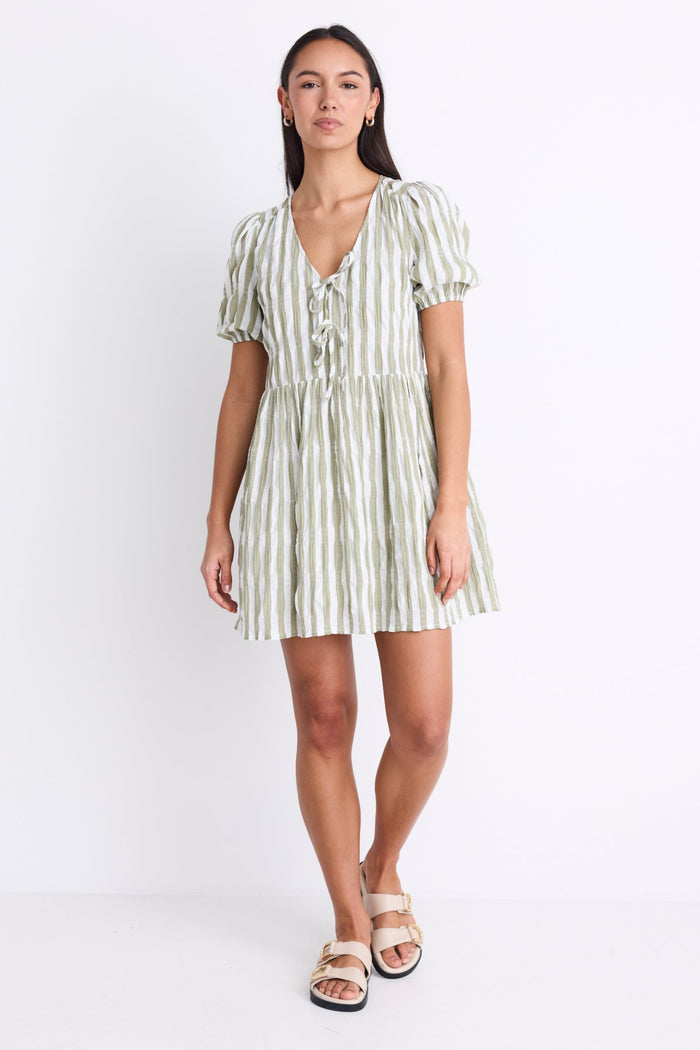 Model wearing a khaki striped puff sleeve mini dress with a V-neckline, puff sleeves, and a tie detail at the front.