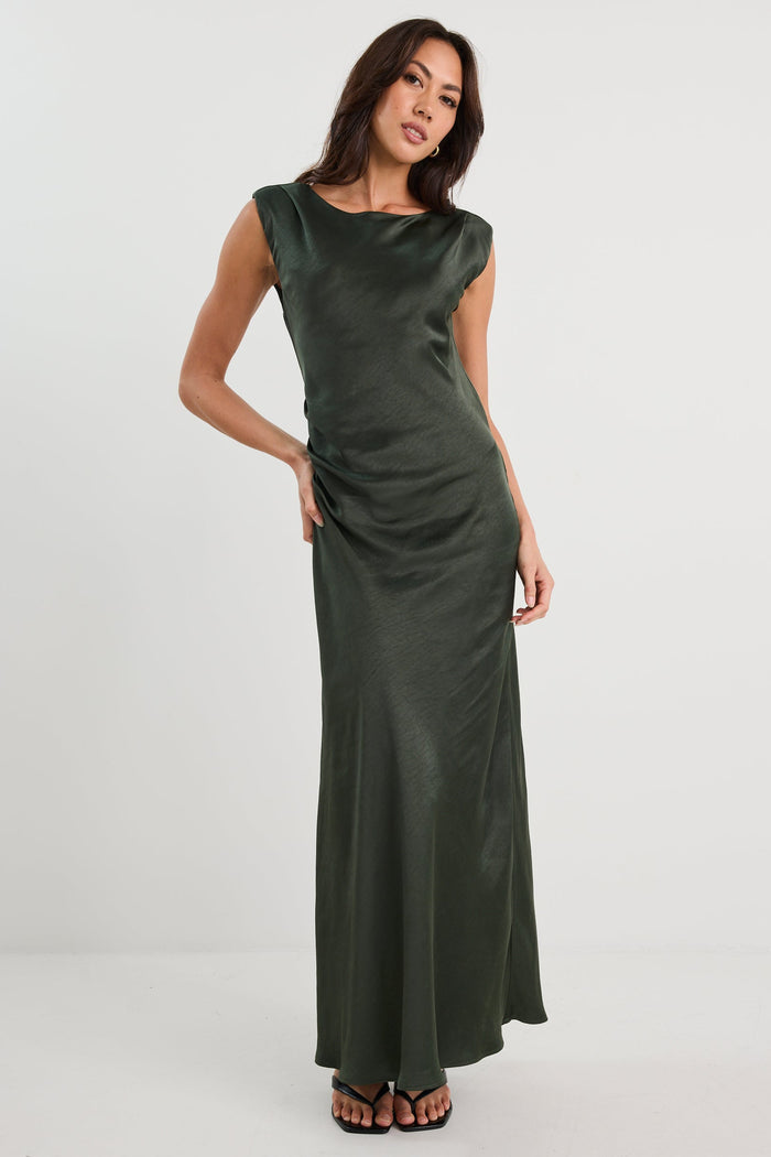 Woman wearing a green evening gown on a white background