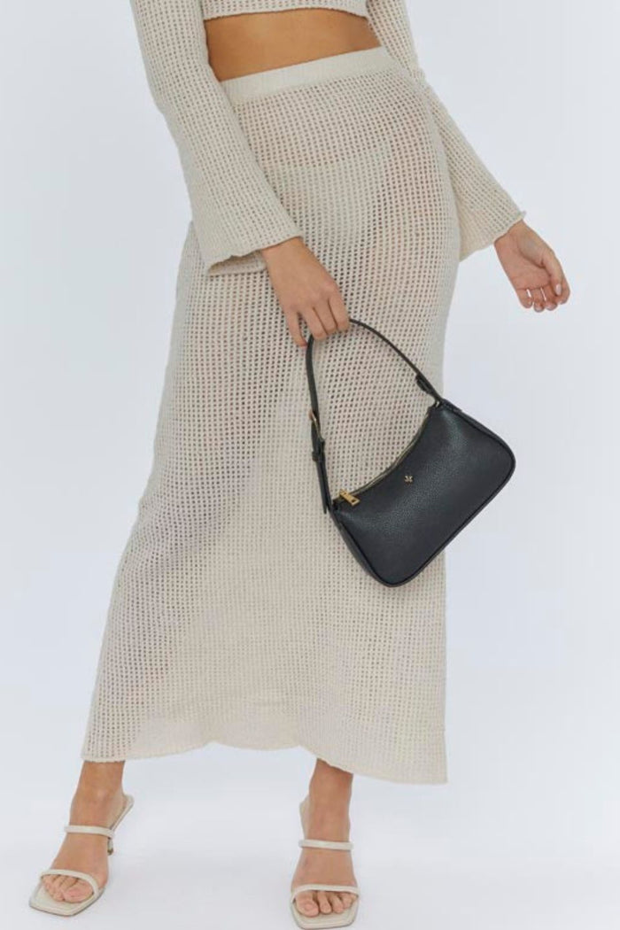model with black leather handbag
