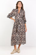 Woman wearing a patterned dress on a white background