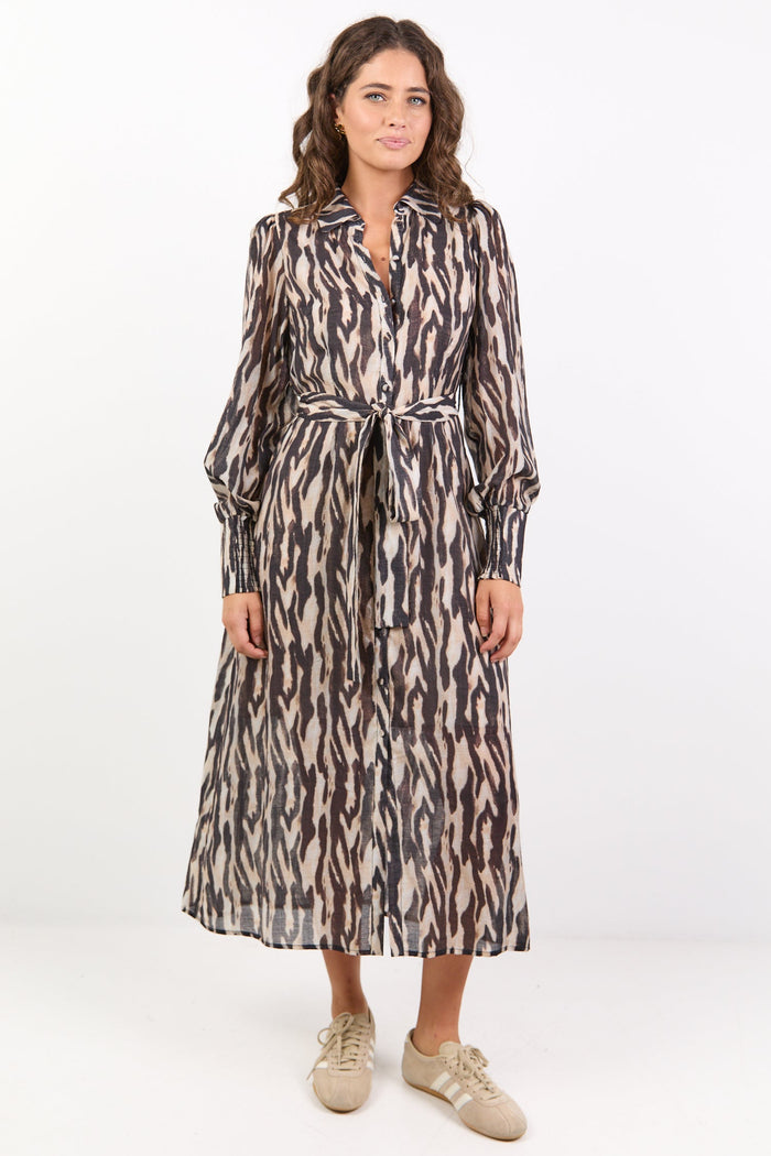 Woman wearing a patterned dress on a white background