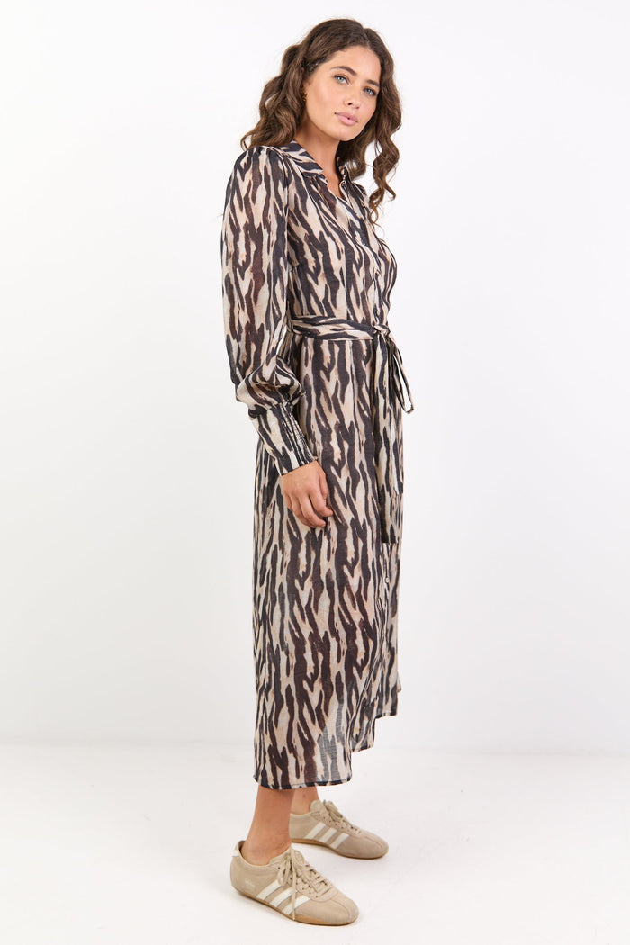 Woman wearing a patterned dress on a white background