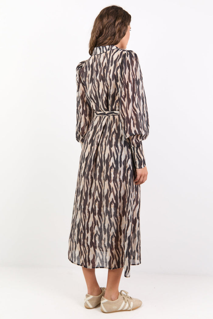 Woman wearing a patterned dress on a white background
