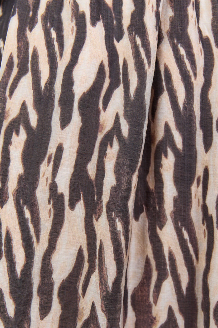Close-up of fabric with a brown and beige abstract pattern
