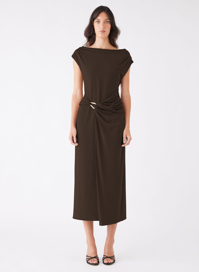 model wears a long brown dress
