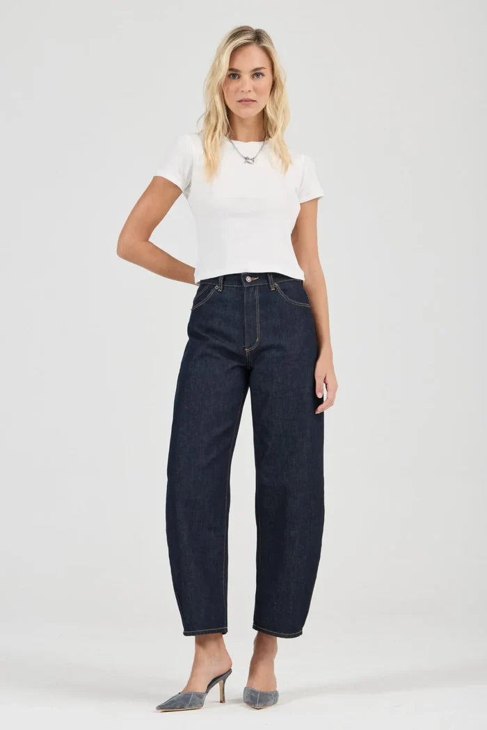 Woman wearing a white t-shirt and dark blue jeans on a white background