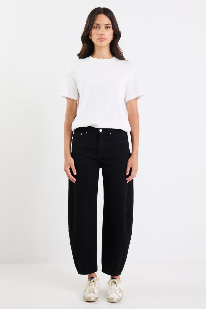 Person wearing a white t-shirt and black jeans on a white background