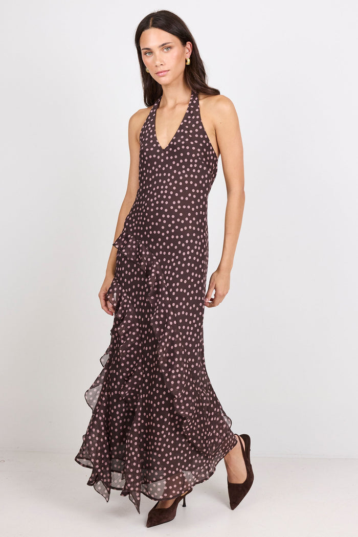 Woman wearing a brown halter maxi dress with pink polka dots on a white background.
col_pattern