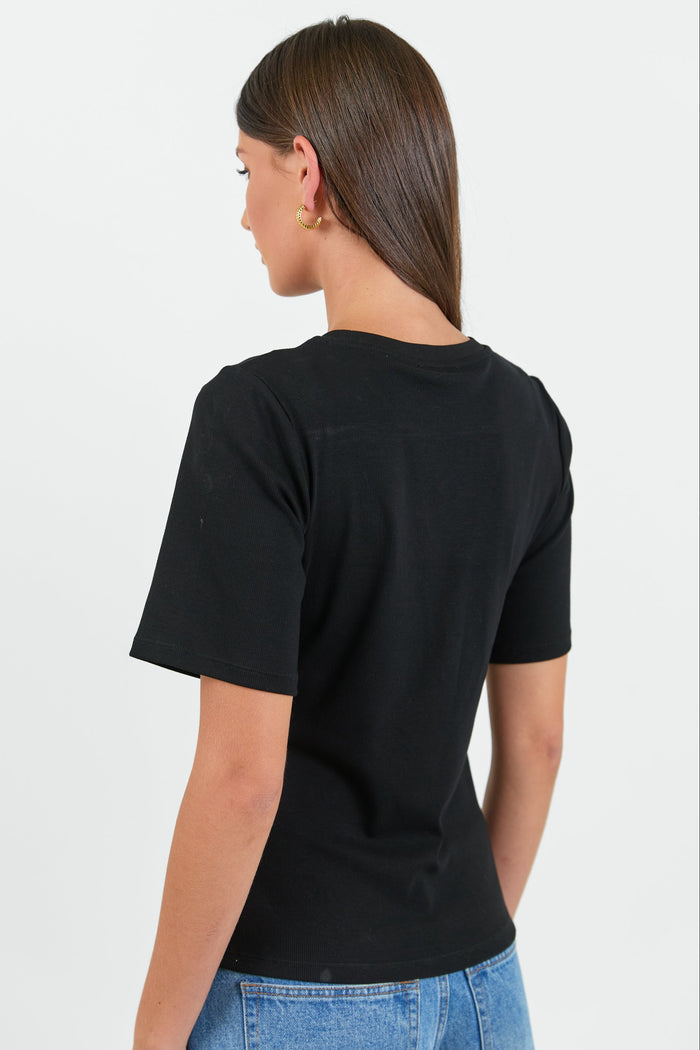 Person wearing a black t-shirt and blue jeans on a white background