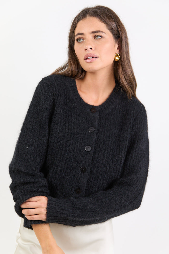 Woman wearing a black cardigan on a white background
