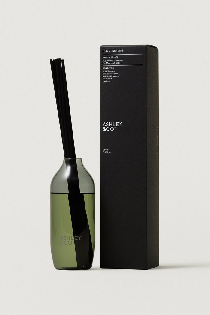 Green diffuser bottle with black cap and packaging box on a white background, featuring the brand 'Ashley & Co'.