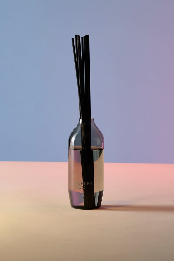 Diffuser with black sticks on a gradient background
