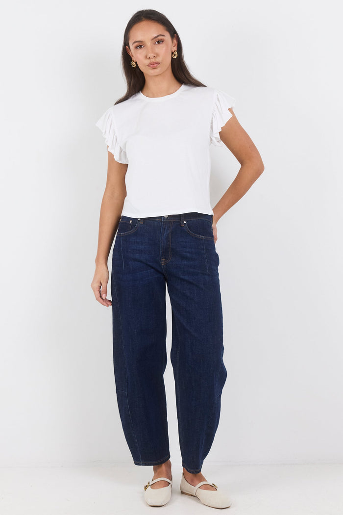 Woman wearing a white t-shirt and dark blue jeans on a white background