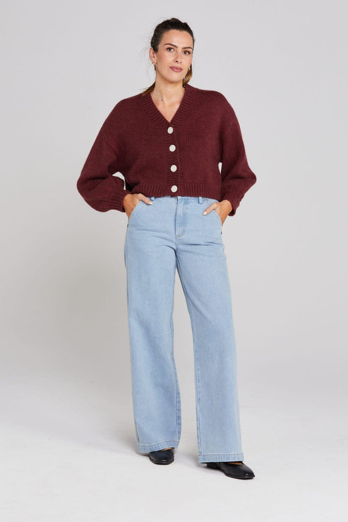 Model wears a burgundy long sleeve knit cardigan