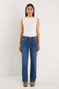 model wears a pair of blue jeans with a white tank top