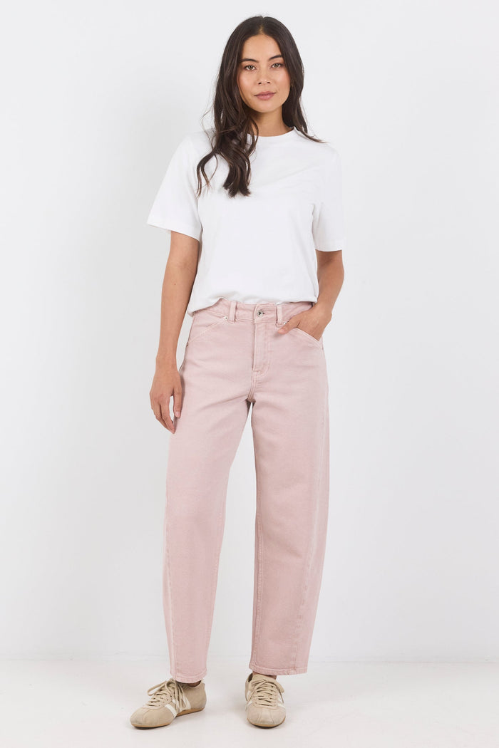Woman wearing a white t-shirt and pink pants on a white background