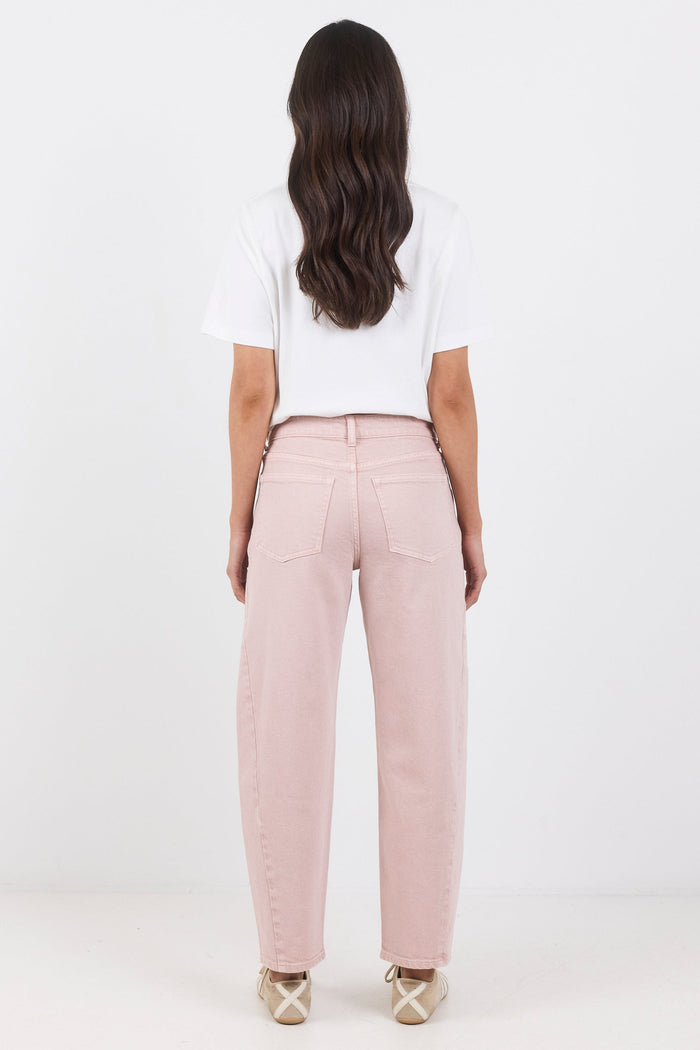 Person wearing pink pants and a white top on a white background