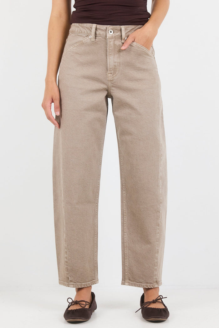 Person wearing beige pants and a brown top on a white background