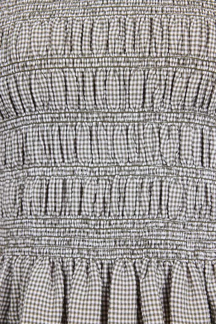 Close-up of a checkered fabric with smocked waistband