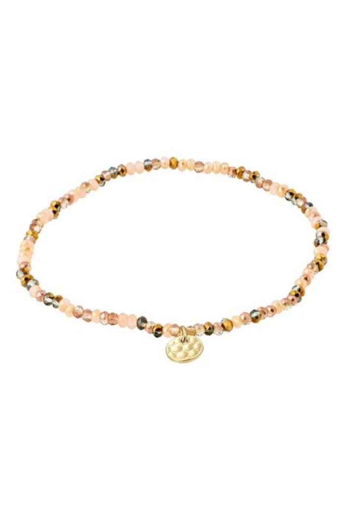 Beaded bracelet with a gold charm on a white background