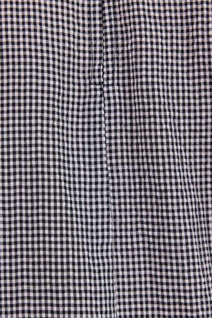 Close-up of a black and white gingham checkered fabric texture.