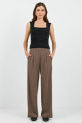 Women wearing black tank and brown pants.