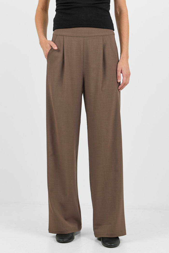 Women wearing black tank and brown pants.