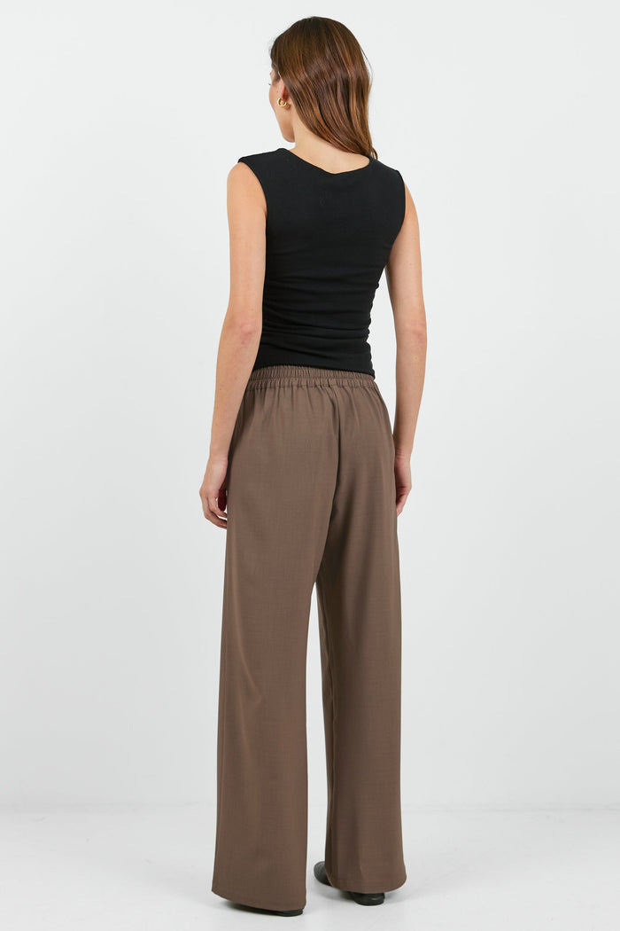 Women wearing black tank and brown pants.