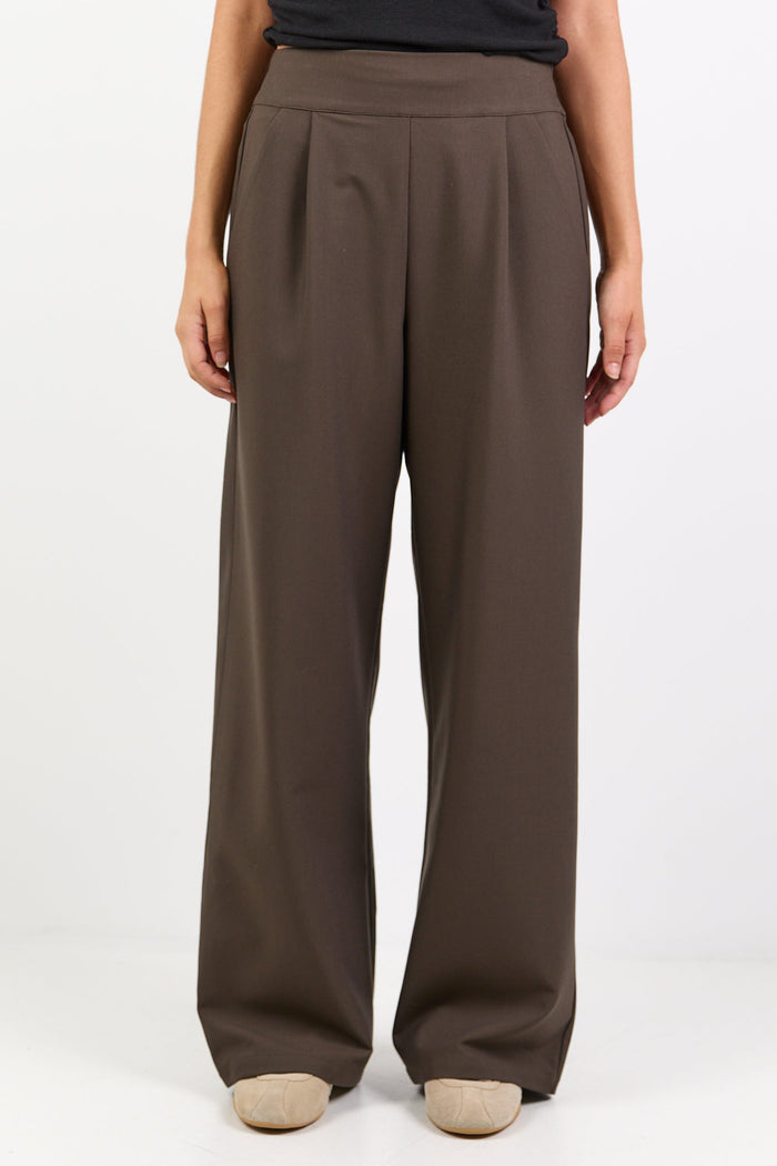 Brown wide-leg pants worn by a person on a white background