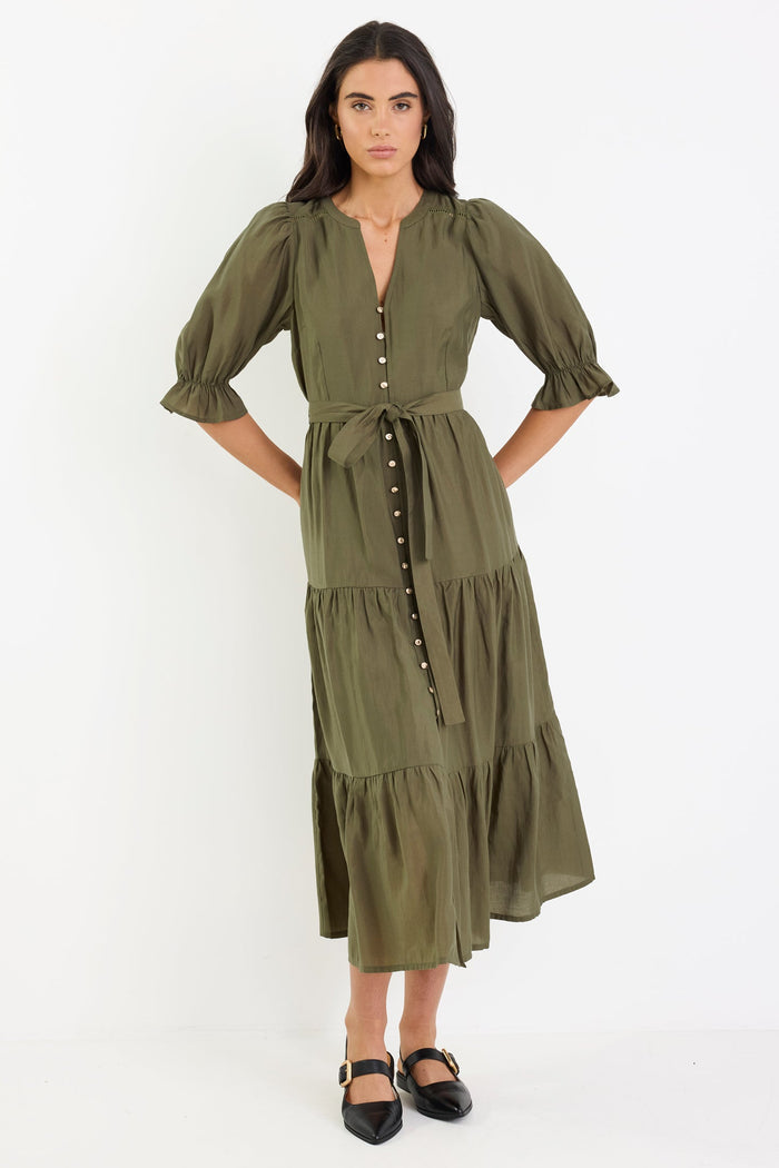 Woman wearing a green dress on a white background
