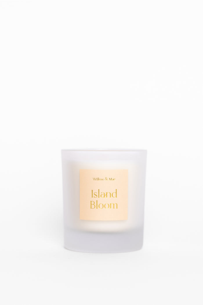 Candle labeled 'Island Bloom' with a white background