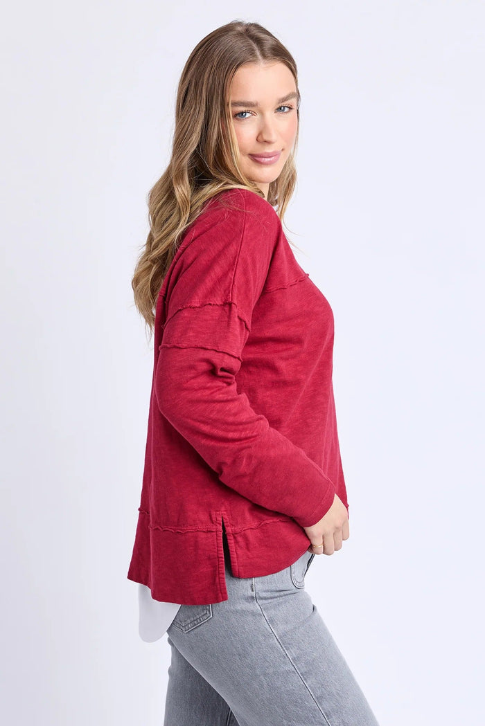Woman wearing a red jacket on a white background