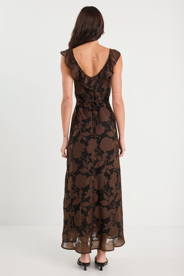 Woman wearing a black floral lace dress on a white background
