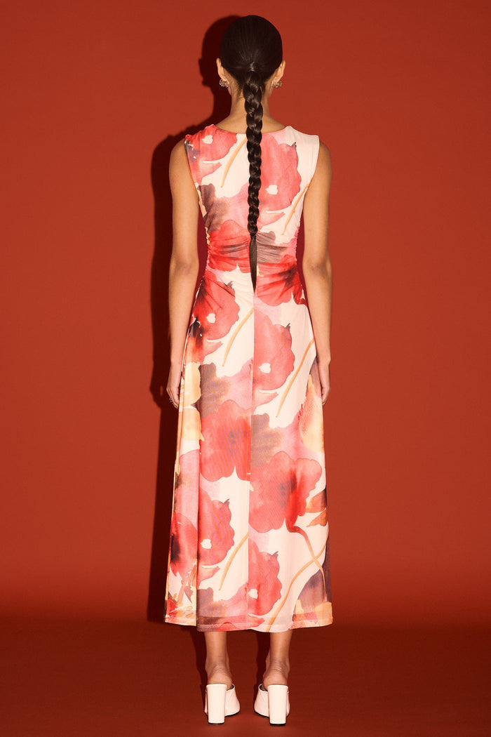 Woman wearing a floral dress with a red background
