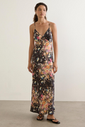 Woman wearing a floral dress with a plain background