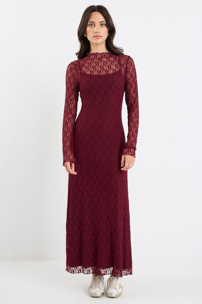 Woman wearing a burgundy lace dress on a white background