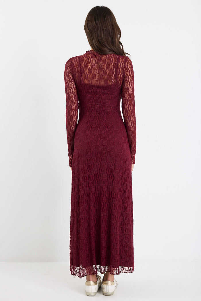 Woman wearing a burgundy lace dress on a white background