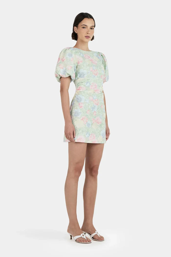 Woman wearing a green floral mini dress